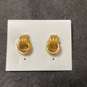 Gold toned earrings.